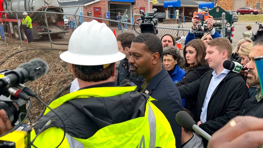 EPA head Michael Regan standing in the middle of people