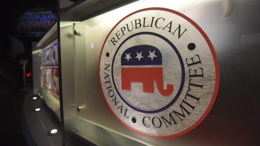 The Republican National Committee logo is shown on the stage as crew members work at the North Charleston Coliseum.