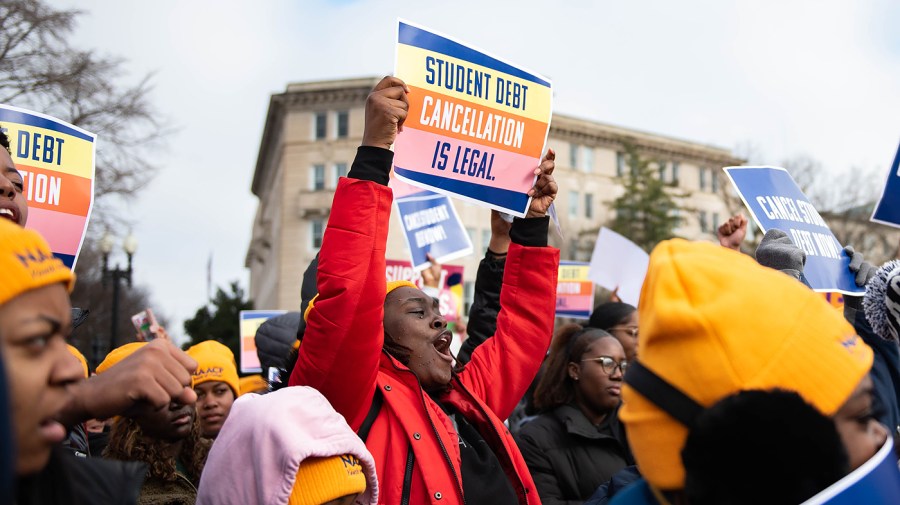 People in favor of President Biden’s student loan forgiveness plan rally in front of the Supreme Court