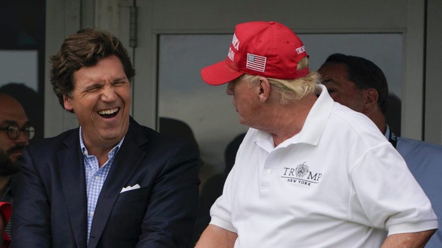 Tucker Carlson and Donald Trump talk during the final round of the Bedminster Invitational LIV Golf tournament in Bedminster, N.J., on July 31, 2022.