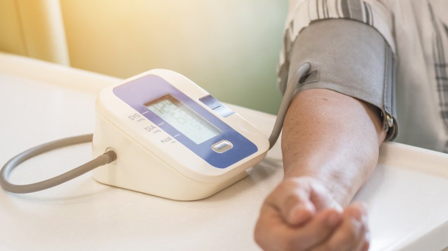 patient getting blood pressure measured by automatic machine