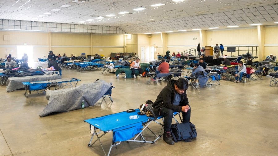 People rest at an evacuation center at Santa Cruz County fairgrounds in Watsonville, Calif., Saturday, March 11, 2023.