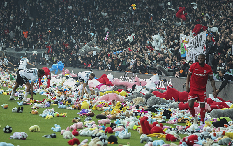 Fans throw toys onto the pitch during the Turkish Super League soccer match