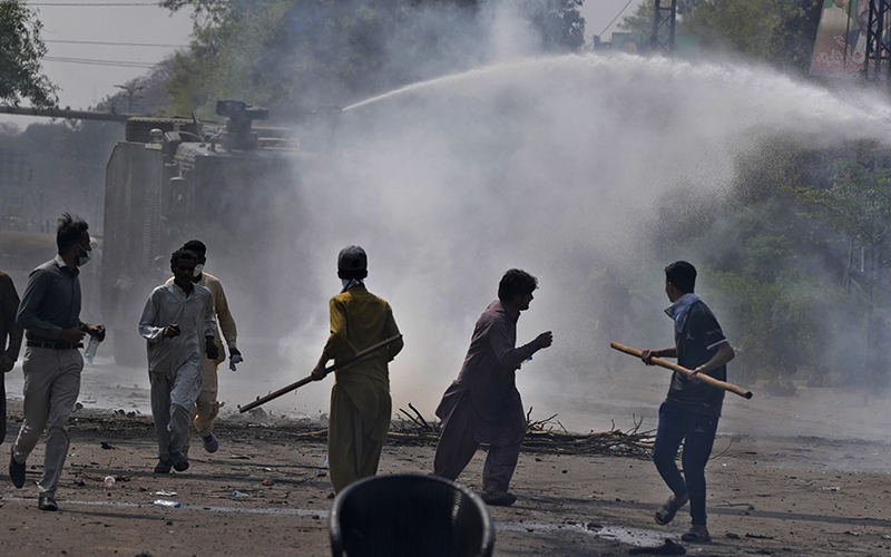 Police use a water cannon to disperse supporters of former Prime Minister Imran Khan during clashes in Lahore, Pakistan