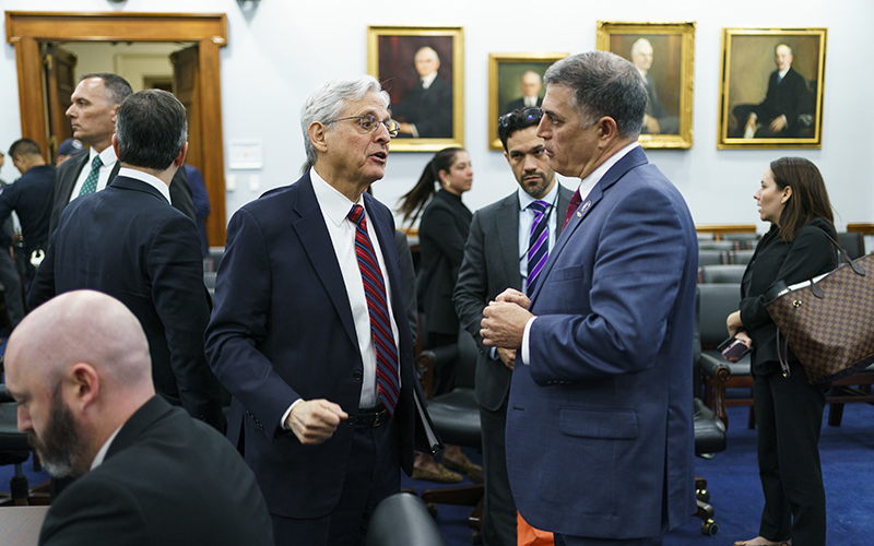 Attorney General Merrick Garland speaks with Rep. Andrew Clyde (R-Ga.) following a House Subcommittee on Commerce, Justice, Science, and Related Agencies hearing