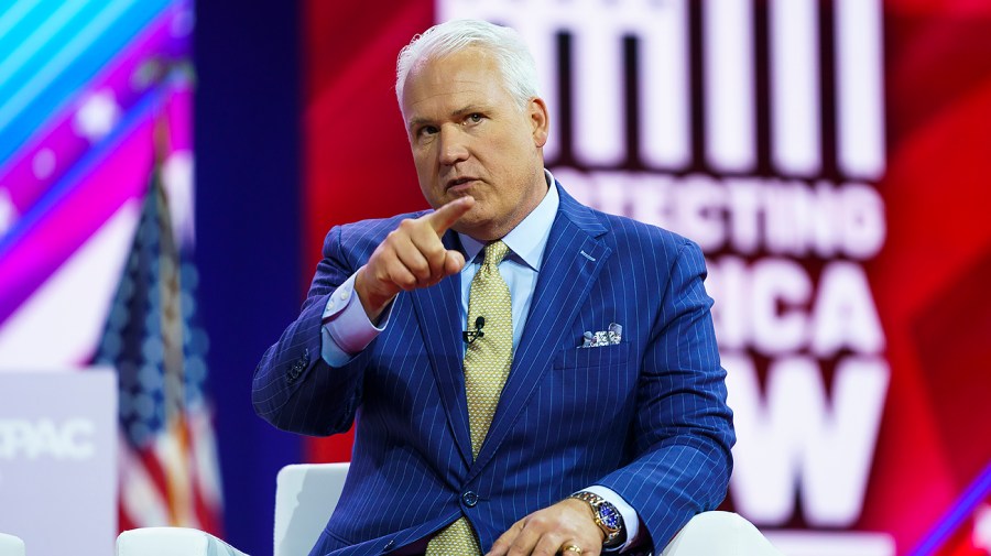 Matt Schlapp points while on stage at an event.