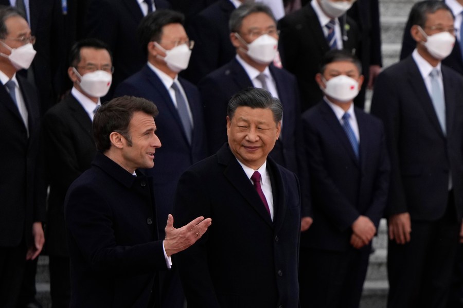 French President Emmanuel Macron, bottom left, chats with Chinese President Xi Jinping during a welcome ceremony held outside the Great Hall of the People in Beijing, Thursday, April 6, 2023. (AP Photo/Ng Han Guan, Pool)