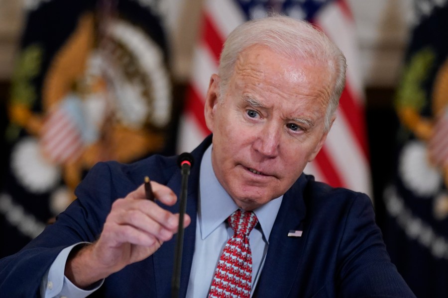 President Joe Biden adjusts his microphone during a meeting with the President's Council of Advisors on Science and Technology in the State Dining Room of the White House, Tuesday, April 4, 2023, in Washington. (AP Photo/Patrick Semansky)