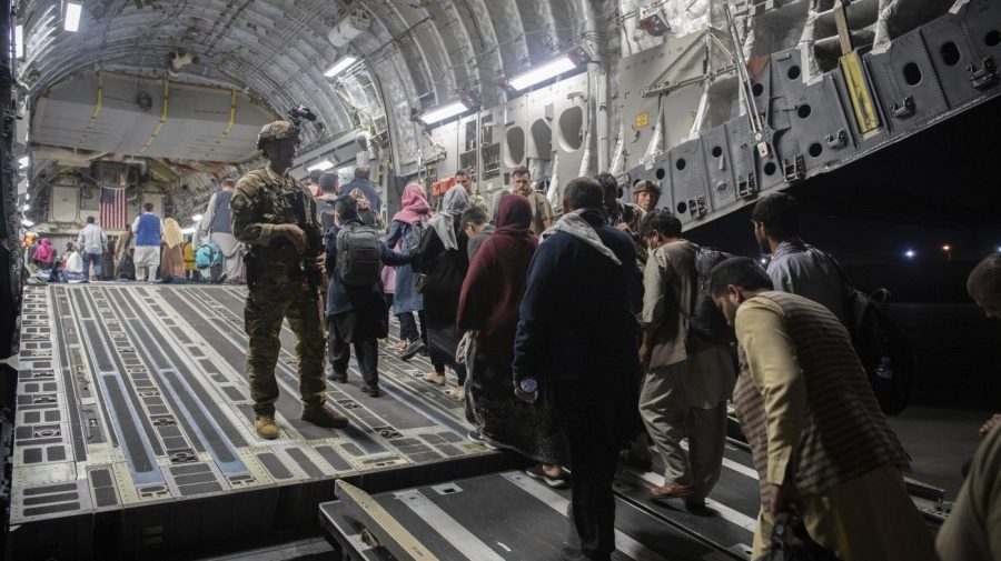 FILE - In this Aug. 22, 2021, file photo provided by the U.S. Air Force, Afghan passengers board a U.S. Air Force C-17 Globemaster III during the Afghanistan evacuation at Hamid Karzai International Airport in Kabul, Afghanistan. (MSgt. Donald R. Allen/U.S. Air Force via AP, File)