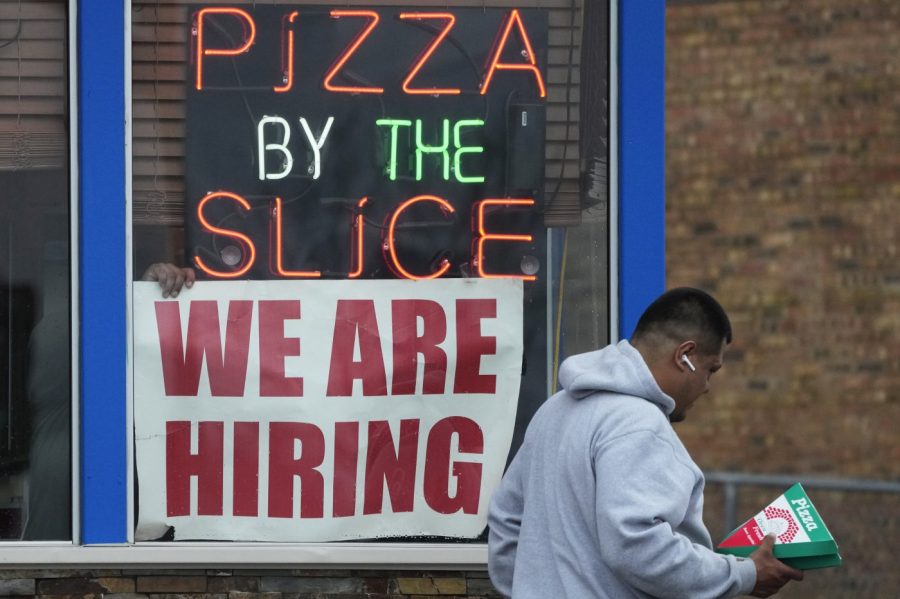 A hiring sign is displayed at a restaurant in Prospect Heights, Ill., Tuesday, April 4, 2023.