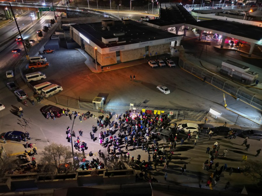 FILE - People take part in a vigil for the victims of a fire at an immigration detention center that killed dozens, outside the detention center in Ciudad Juarez, Mexico, March 28, 2023. Two guards who fled a fire that killed 40 migrants in a locked Mexican detention center did not have keys to the cell door, Mexico’s president said Tuesday, April 11, 2023. (AP Photo/Christian Chavez, File)