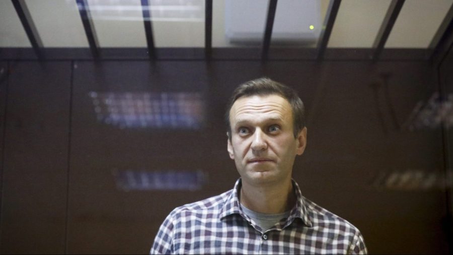 FILE - Russian opposition leader Alexei Navalny stands in a cage in the Babuskinsky District Court in Moscow, Russia, Feb. 20, 2021. (AP Photo/Alexander Zemlianichenko, File)