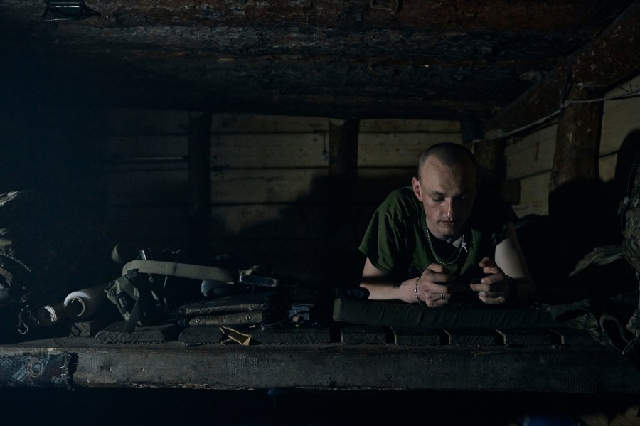 A Ukrainian soldier rests in a shelter at his position on the frontline in Bakhmut, Donetsk region, Ukraine, Thursday, April 13, 2023. (AP Photo/Libkos)