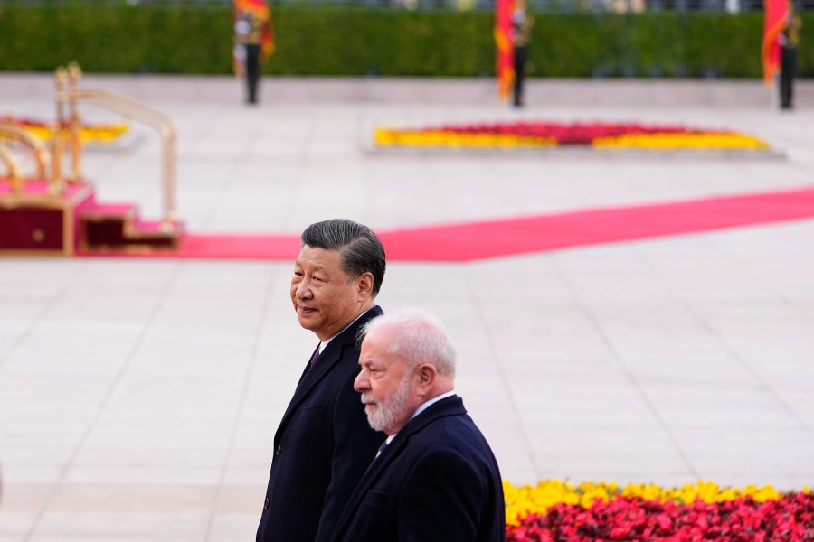 Brazilian President Luiz Inacio Lula da Silva, right, and Chinese President Xi Jinping walk during a welcome ceremony outside the Great Hall of the People in Beijing Friday, April 14, 2023. (Ken Ishii/Pool Photo via AP)