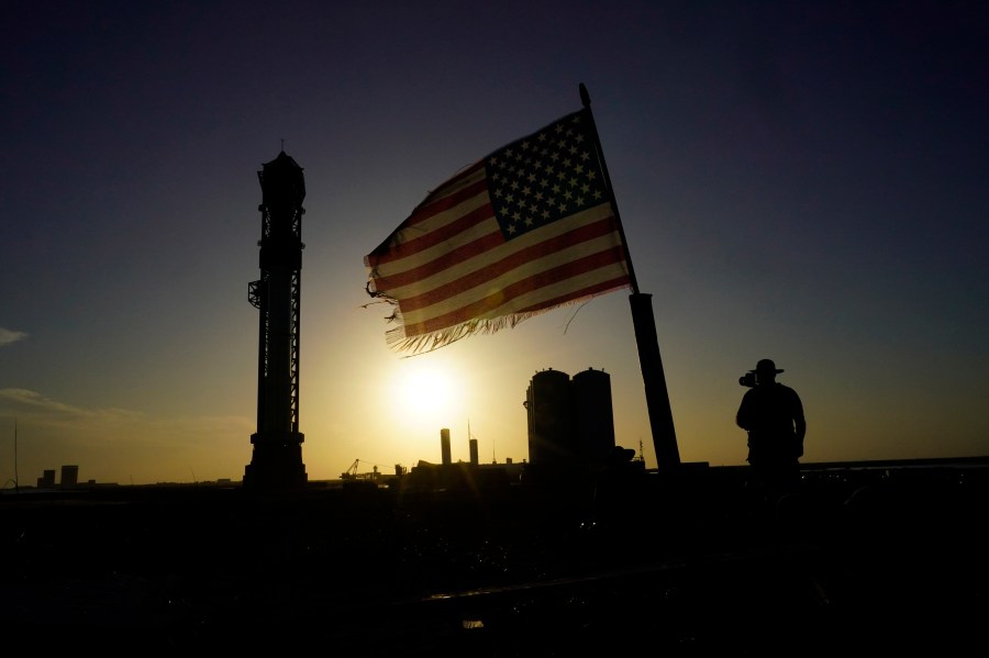 Onlookers watch as SpaceX's Starship, the world's biggest and most powerful rocket, stands ready for launch in Boca Chica, Texas, Sunday, April 16, 2023. The test launch is scheduled for Monday. (AP Photo/Eric Gay)