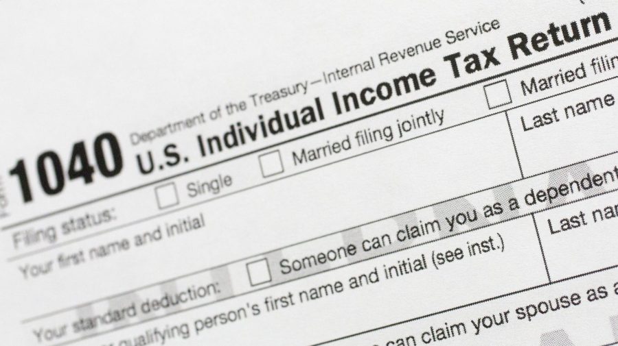 FILE - A portion of the 1040 U.S. Individual Income Tax Return form is shown July 24, 2018, in New York. The IRS has been tasked with looking into how to create a government-operated electronic free-file tax return system for all. Congress has directed the IRS to report in on how such a system might work. (AP Photo/Mark Lennihan, File)