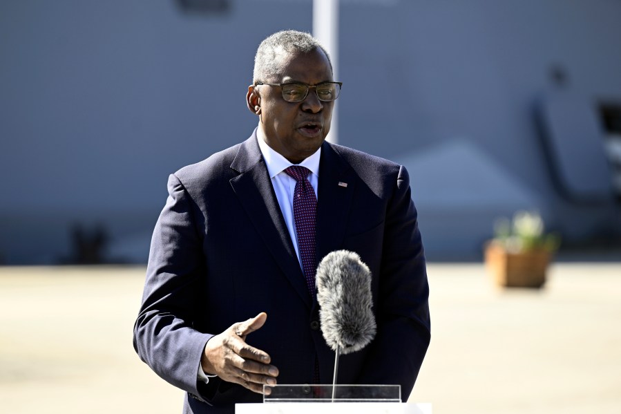 U.S. Defense Secretary Lloyd Austin and Sweden's Defense Minister Pal Jonson, unseen, speak at the Muskö Naval Base, in Stockholm, Sweden, Wednesday, April 19, 2023. The U.S. is sending Ukraine about $325 million in additional military aid, including an enormous amount of artillery rounds and ammunition as the launch of the spring offensive against Russian forces approaches, the Pentagon said Wednesday. (Fredrik Sandberg/TT News Agency via AP)