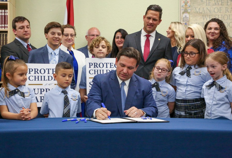 FILE - Florida Gov. Ron DeSantis signs the Parental Rights in Education bill at Classical Preparatory school on March 28, 2022, in Shady Hills, Fla. The Florida Board of Education on Wednesday, April 19, 2023, approved a ban on classroom instruction about sexual orientation and gender identity in all grades, expanding the law critics call “Don't Say Gay” at the request of Gov. DeSantis as he gears up for an expected presidential run. (Douglas R. Clifford/Tampa Bay Times via AP, File)