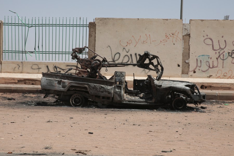 A destroyed military vehicle is seen in southern in Khartoum, Sudan, Thursday, April 20, 2023. The latest attempt at a cease-fire between the rival Sudanese forces faltered as gunfire rattled the capital of Khartoum. Through the night and into Thursday morning, gunfire could be heard almost constantly across Khartoum. (AP Photo/Marwan Ali)