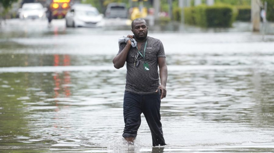 FILE - A man walks out of a flooded neighborhood Thursday, April 13, 2023, in Fort Lauderdale, Fla. Florida Gov. Ron DeSantis Saturday, April 22, 2023, is asking the Biden administration to declare Broward County a disaster area due to flooding earlier this month after record rainfall. (AP Photo/Marta Lavandier, File)