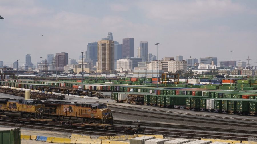 Los Angeles skyline is seen above the Union Pacific LATC Intermodal Terminal is seen on Tuesday, April 25, 2023 in Los Angeles. California's Air Resources Board is set to vote on a rule to cut greenhouse gas and smog-forming emissions from diesel-powered locomotives used to pull rail cars through ports and railyards. (AP Photo/Damian Dovarganes)