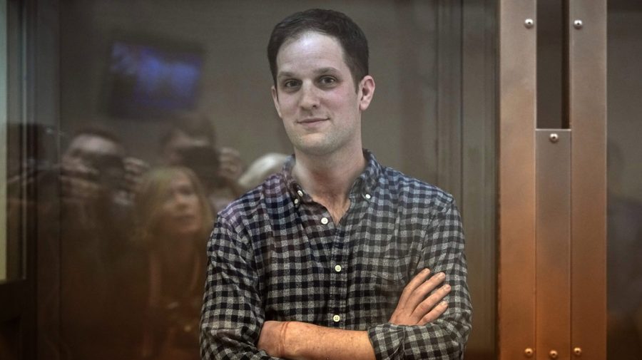 FILE - Wall Street Journal reporter Evan Gershkovich stands in a glass cage in a courtroom at the Moscow City Court, in Moscow, Russia, Tuesday, April 18, 2023. The Biden administration on Thursday, April 27, sanctioned Russia's Federal Security Service and Iran's Islamic Revolutionary Guard Corps intelligence organization for wrongfully detaining Americans. They noted that Thursday's actions were in the works well before the arrest of Gershkovich in Russia, whose imprisonment was swiftly deemed unjust by the U.S. government. (AP Photo/Alexander Zemlianichenko, File)