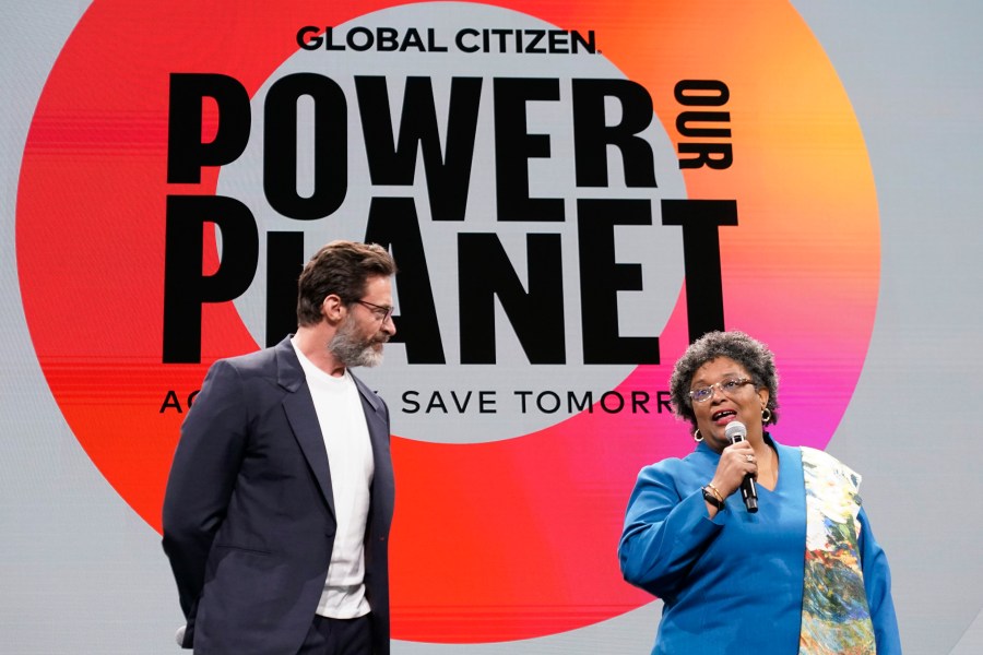 Actor Hugh Jackman, left, is joined by Prime Minister of Barbados Mia Mottley onstage at the Global Citizen NOW Summit, Thursday, April 27, 2023, in New York. (AP Photo/Mary Altaffer)