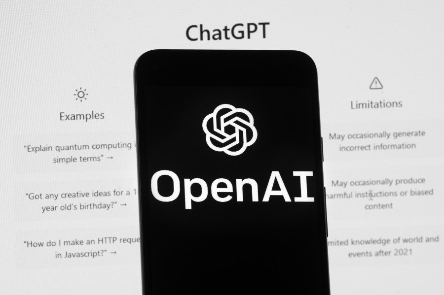 FILE - The OpenAI logo is seen on a mobile phone in front of a computer screen which displays the ChatGPT home Screen, on March 17, 2023, in Boston. ChatGPT's maker said Friday April 28, 2023 that the artificial intelligence chatbot is available again in Italy after the company met the demands of regulators who temporarily blocked it over privacy concerns. (AP Photo/Michael Dwyer, File)