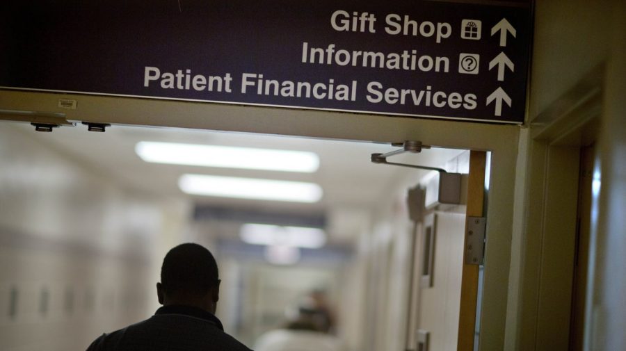 FILE - A sign points visitors toward the financial services department at a hospital, Friday, Jan. 24, 2014. More than a half million of the poorest Americans would be left without health insurance under legislation passed by House Republicans that would require people to work in exchange for health care coverage through Medicaid. The bill is unlikely to become law, though, with Democrats strongly opposing the idea. (AP Photo/David Goldman, File)