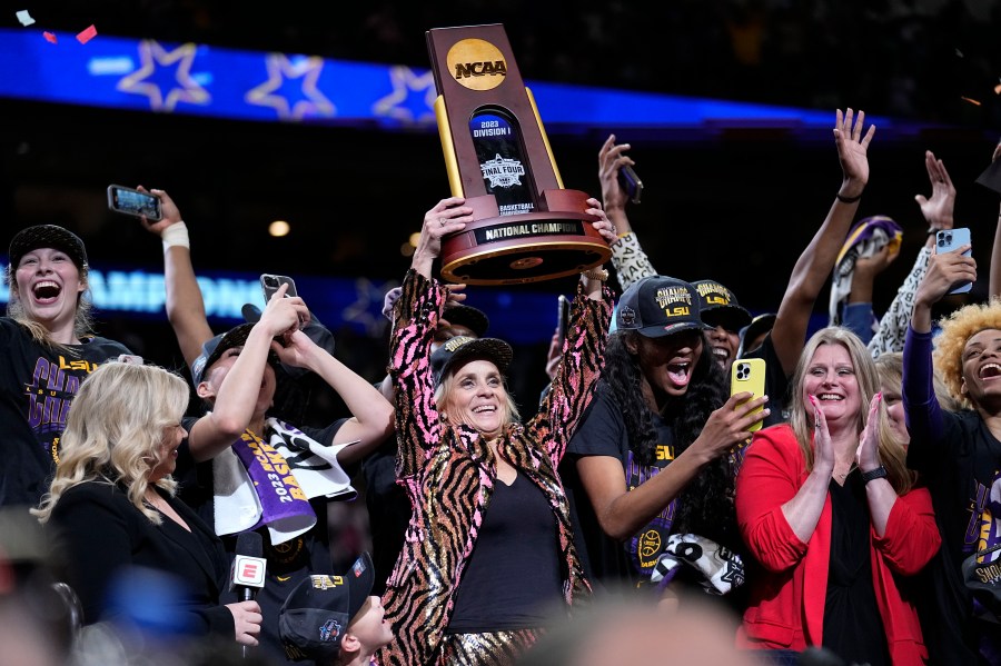 LSU head coach Kim Mulkey holds the winning trophy after the NCAA Women's Final Four championship basketball game