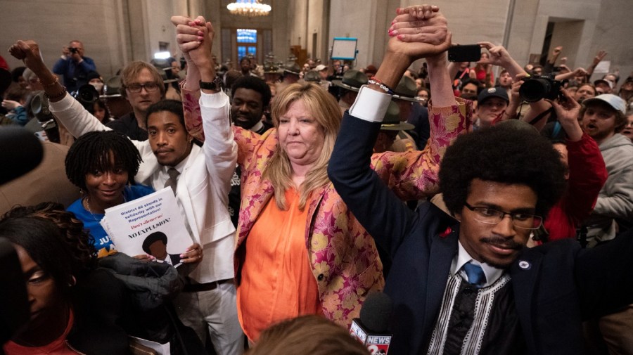 Former Rep. Justin Jones, D-Nashville, Rep. Gloria Johnson, D-Knoxville, and former Rep. Justin Pearson, D-Memphis, raises their hands outside the House chamber after Jones and Pearson were expelled from the legislature Thursday, April 6, 2023, in Nashville, Tenn.