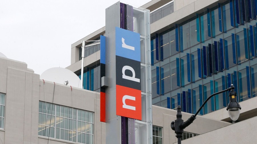 The red, black and blue NPR logo is seen on the side of a building.