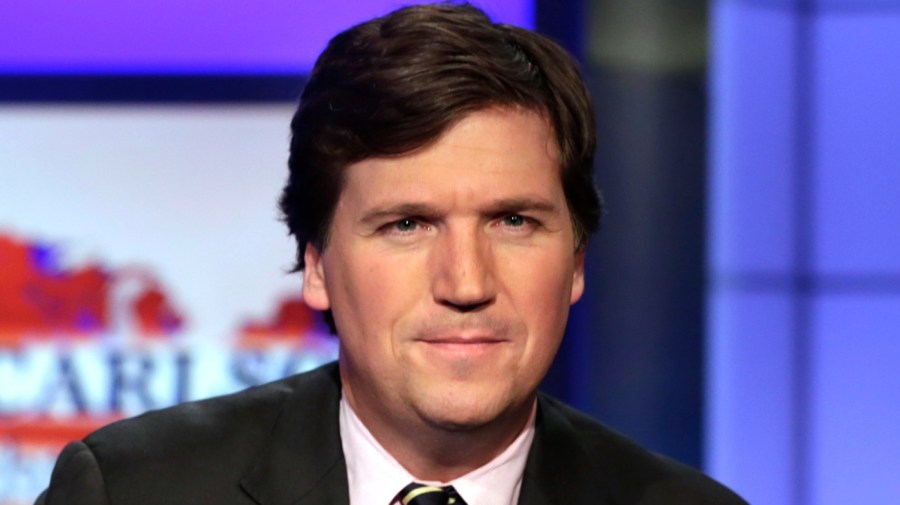 FILE - In this March 2, 2017 file photo, Tucker Carlson, host of "Tucker Carlson Tonight," poses for photos in a Fox News Channel studio, in New York.