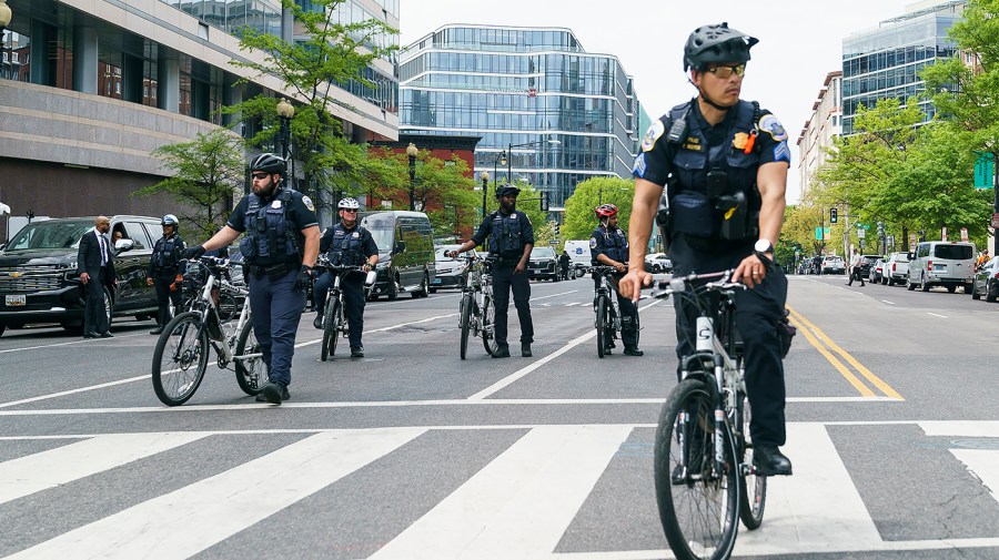 Washington, D.C., Metropolitan Police are seen as climate protesters from multiple organizations calling for an end of fossil fuel funding demonstrate outside the International Monetary Fund