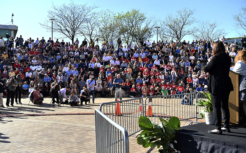 A crowd of mourners sit in bleachers during a vigil for the victims of Monday's shooting in Louisville, Ky.