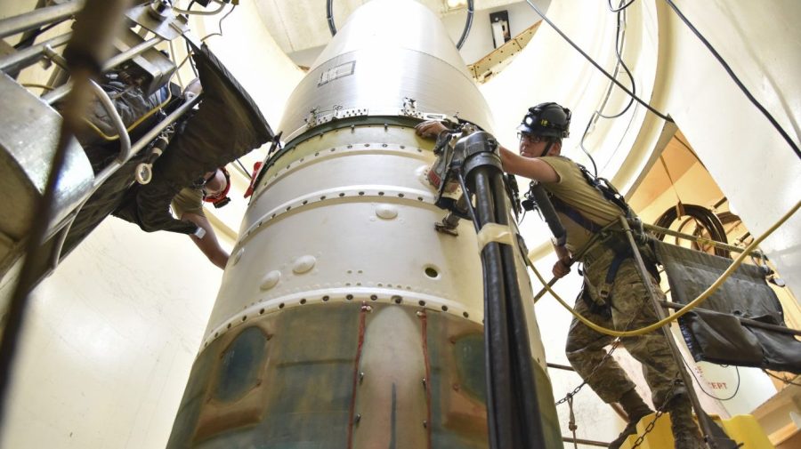 FILE - In this image provided by the U.S. Air Force, Airman 1st Class Jackson Ligon, left, and Senior Airman Jonathan Marinaccio, 341st Missile Maintenance Squadron technicians, connect a re-entry system to a spacer on an intercontinental ballistic missile during a Simulated Electronic Launch-Minuteman test Sept. 22, 2020, at a launch facility near Malmstrom Air Force Base in Great Falls, Mont. The Air Force says a review of a Montana nuclear missile base where an unusual number of troops have reported being diagnosed with non-Hodgkin's lymphoma has found no immediate risk factors. The same was true at two other bases that could launch ground-based warheads, the service said in a report obtained by the Associated Press. (Senior Airman Daniel Brosam/U.S. Air Force via AP, File)