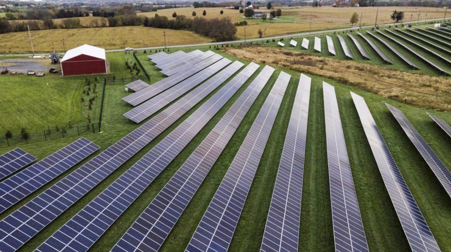 FILE - Farmland is seen with solar panels from Cypress Creek Renewables, Oct. 28, 2021, in Thurmont, Md. The Senate has approved a measure that would reinstate tariffs on solar panel imports from several Southeast Asian countries after President Joe Biden paused them in a bid to boost solar installations in the U.S. (AP Photo/Julio Cortez, File)