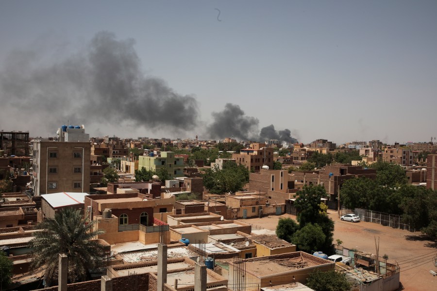 FILE - Smoke rises in Khartoum, Sudan, on April 22, 2023. In the country's capital, Sudan's army and the paramilitary group known as the Rapid Support Forces have battled in the streets with automatic rifles, artillery and airstrikes. An AP journalist, waiting for a chance to leave the country, sheltered with a diverse group of more than a dozen people who hunkered down in a small hotel in central Khartoum. (AP Photo/Marwan Ali, File)