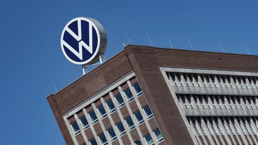 FILE - The Volkswagen logo stand on the top of a VW headquarters building in Wolfsburg, Germany, Monday, April 27, 2020. Volkswagen profits fell 30% in the first three months of the year despite booming business in Europe and North America because sales dropped in China, where the German automaker is facing increasing competition from homegrown models. (Swen Pfoertner/dpa via AP, File)