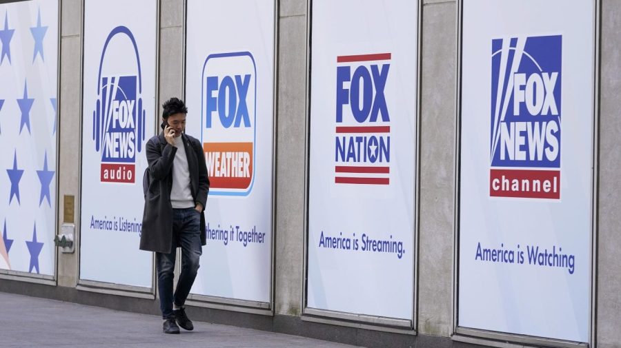 A man walks past the News Corp. and Fox News headquarters on Wednesday, April 19, 2023, in New York.