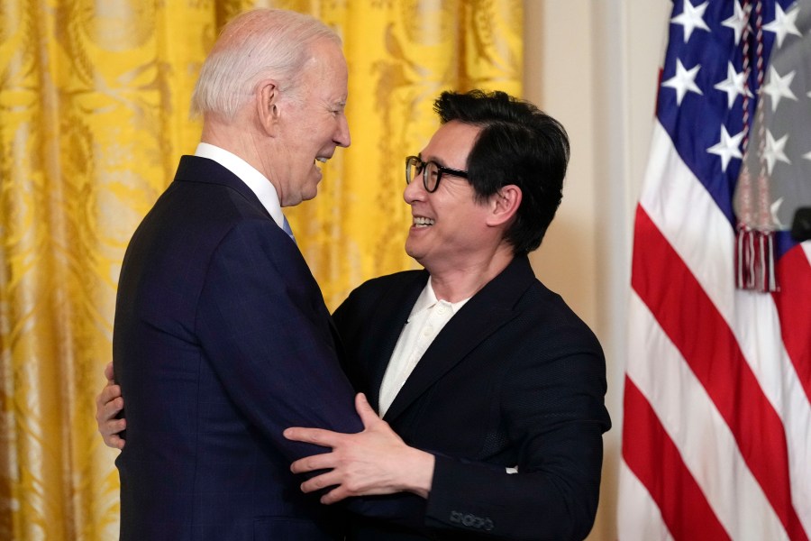 Actor Ke Huy Quan hugs President Joe Biden after he introduced Biden to speak before a screening of the series "American Born Chinese" in the East Room of the White House in Washington. The screening was held in celebration of Asian American, Native Hawaiian, and Pacific Islander Heritage Month, Monday, May 8, 2023. (AP Photo/Susan Walsh)