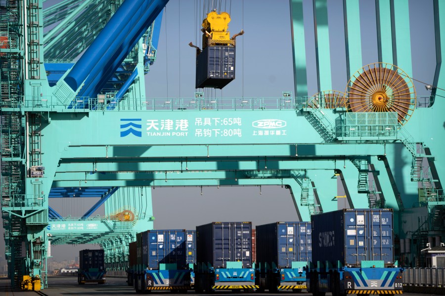 Driverless trucks move shipping containers at a port in Tianjin, China, Monday, Jan. 16, 2023. Chinese exports grew in April by 8.5% to $295.4 billion compared with a year earlier despite weakening global demand. (AP Photo/Mark Schiefelbein)