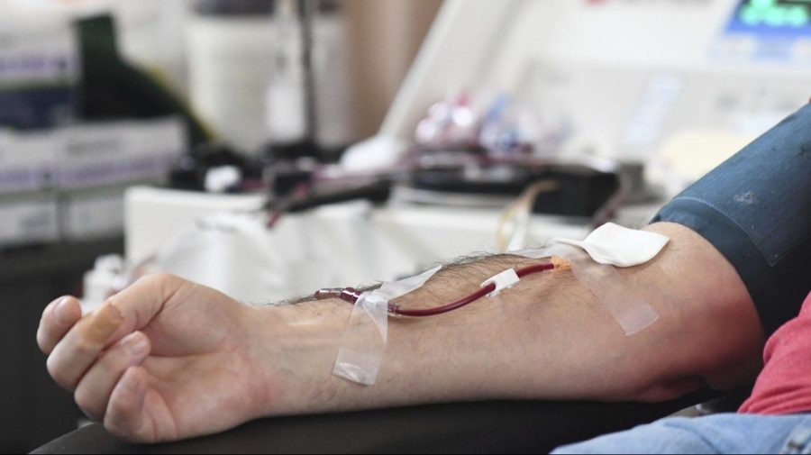 FILE - A person donates blood to the American Red Cross during a blood drive in Pottsville, Pa. on Thursday, Jan. 13, 2022.