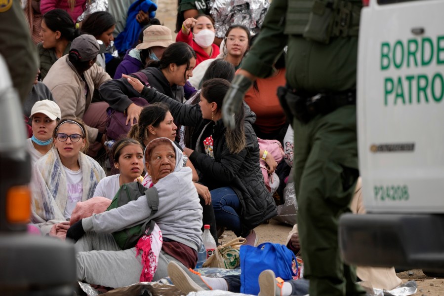 People wait to apply for asylum between two border walls Thursday, May 11, 2023, in San Diego. Many of the hundreds of migrants between the walls that separate Tijuana, Mexico, with San Diego have been waiting for days to apply for asylum.