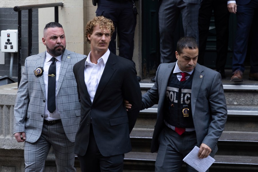 Daniel Penny, center, is walked by New York Police Department detectives detectives out of the 5th Precinct on Friday, May. 12, 2023 in New York. Manhattan prosecutors announced Thursday they would bring the criminal charge against Penny, 24, a U.S. Marine Corps veteran, in the May 1 death of 30-year-old Jordan Neely. (AP Photo/Jeenah Moon)