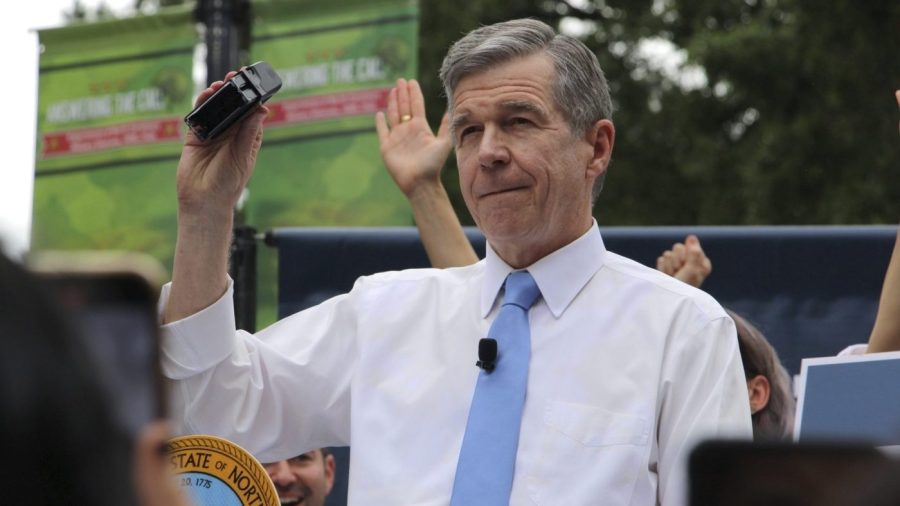 North Carolina Democratic Gov. Roy Cooper affixes his veto stamp to a bill banning nearly all abortions after 12 weeks of pregnancy at a public rally Saturday, May 13, 2023, in Raleigh, N.C. The veto launches a major test for leaders of the GOP-controlled General Assembly to attempt to override Cooper’s veto after they recently gained veto-proof majorities in both chambers. (AP Photo/Hannah Schoenbaum)