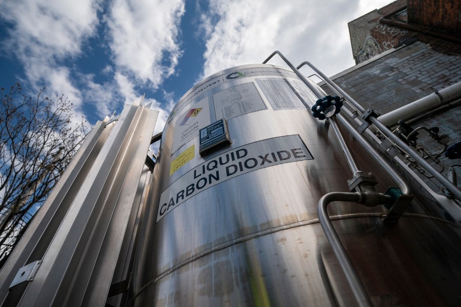 FILE - A liquid carbon dioxide containment unit stands outside the fabrication building of Glenwood Mason Supply Company, April 18, 2023, in the Brooklyn borough of New York. The Biden administration announced on Wednesday, May 17, $251 million for carbon capture and storage projects in seven states. (AP Photo/John Minchillo, File)