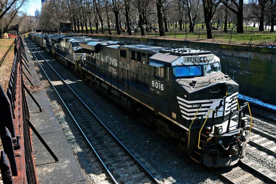 FILE - A Norfolk Southern freight train rolls through downtown Pittsburgh, on March 26, 2018. The union that represents railroad engineers finally secured its first deal for paid sick time with Norfolk Southern several months after other rail unions began reaching similar agreements with the major freight railroads. The Brotherhood of Locomotive Engineers and Trainmen announced the deal with the railroad Thursday, May 18, 2023. (AP Photo/Gene J. Puskar, File)