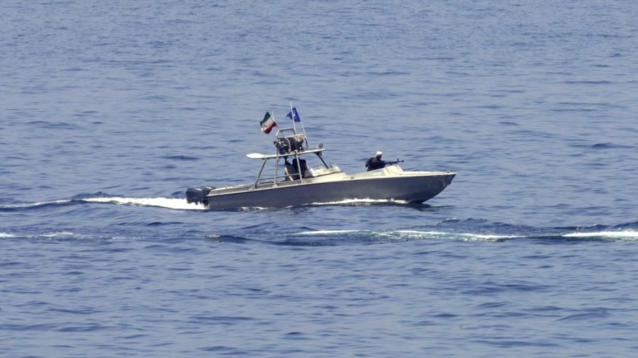 An Iranian Revolutionary Guard vessel watches an American warship in the Strait of Hormuz Friday, May 19, 2023. (AP Photo/Jon Gambrell)