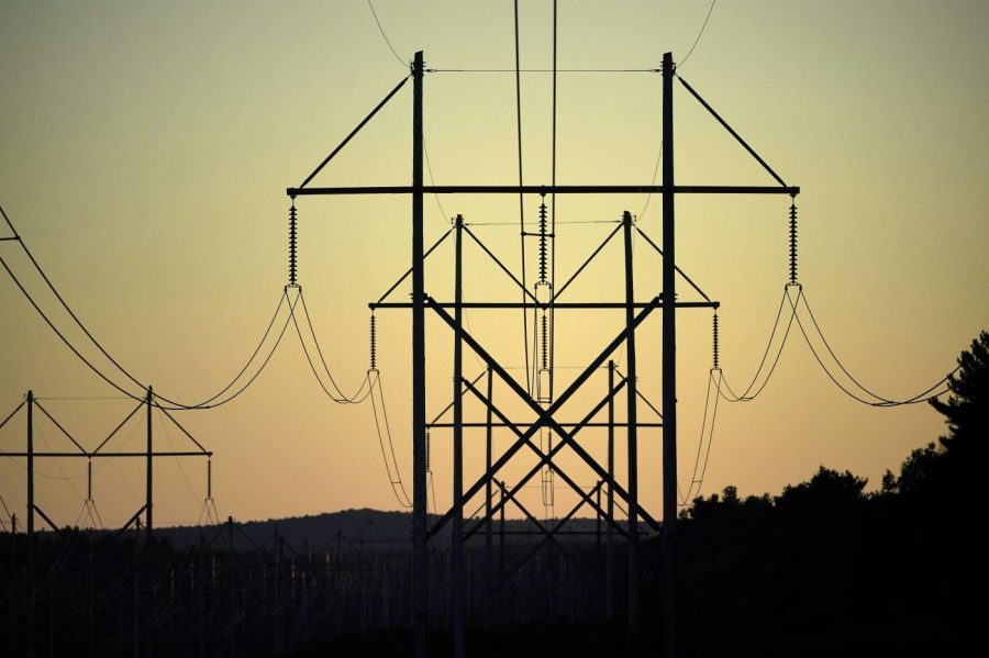 FILE - Central Maine Power utility lines are seen on Oct. 6, 2021, in Pownal, Maine. It’s one of President Joe Biden’s thorniest challenges as he pursues ambitious reductions in greenhouse gas emissions. If he can't streamline the permitting process for power plants, transmission lines and other projects, the country is unlikely to have the infrastructure needed for a future powered by carbon-free electricity. (AP Photo/Robert F. Bukaty, File)